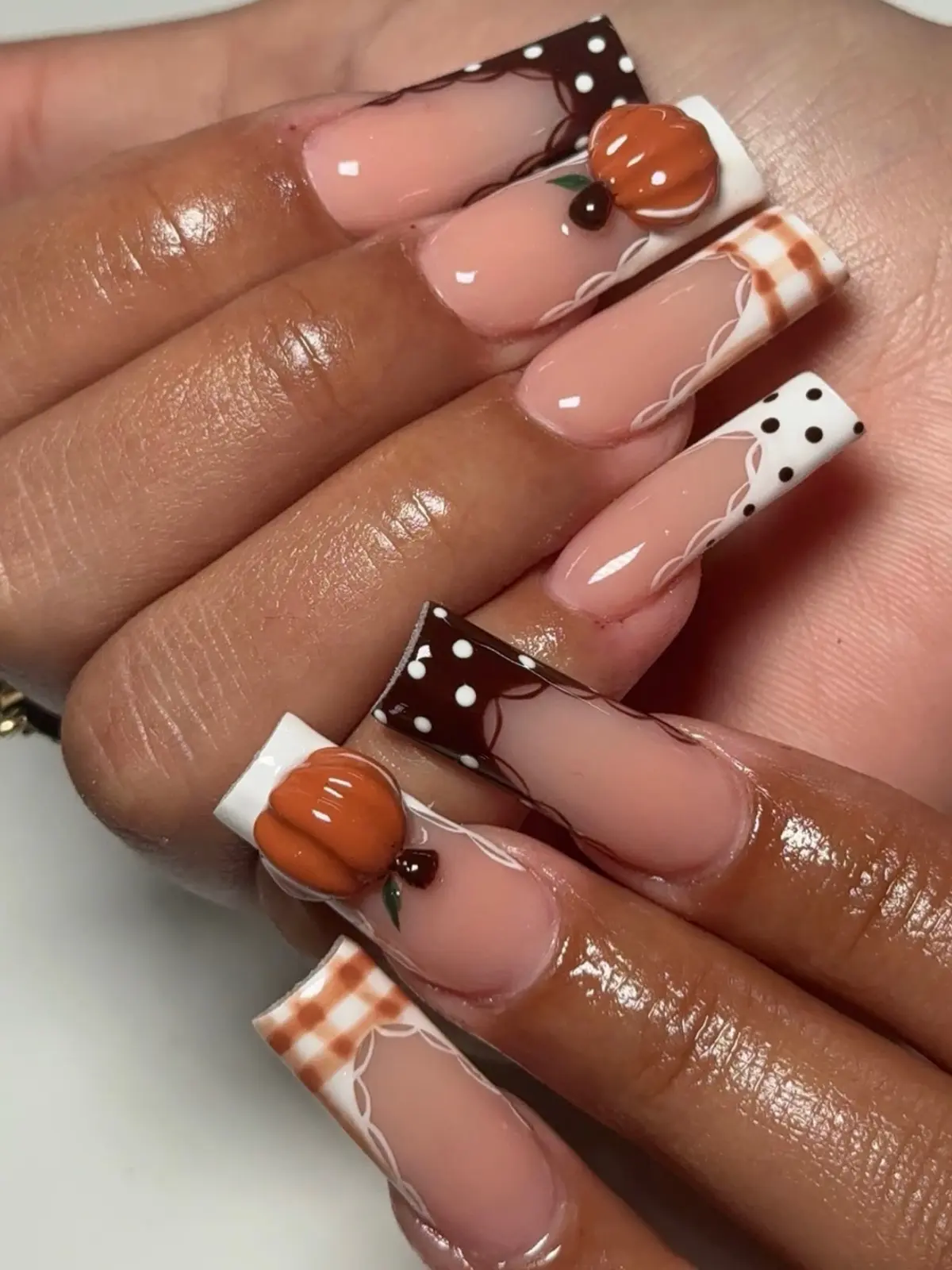 Long square nails with sculpted 3D pumpkins, orange plaid tips and chocolate polka-dot French tips