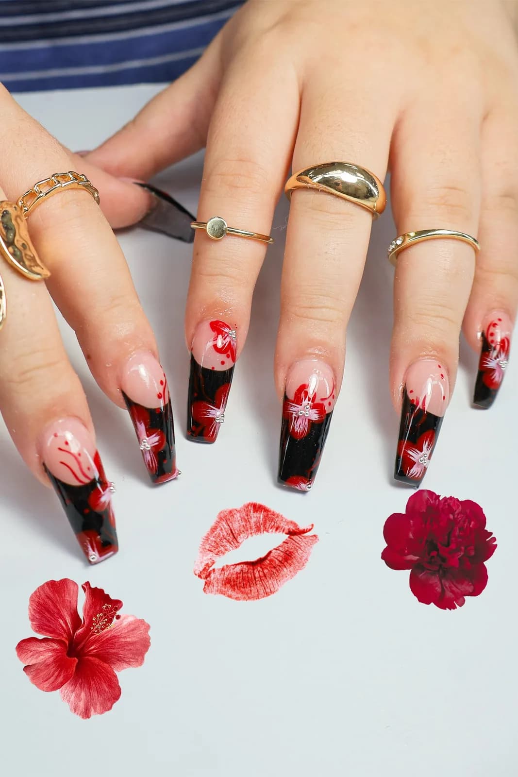 Long coffin nails with glossy black tips and hand-painted red hibiscus flowers