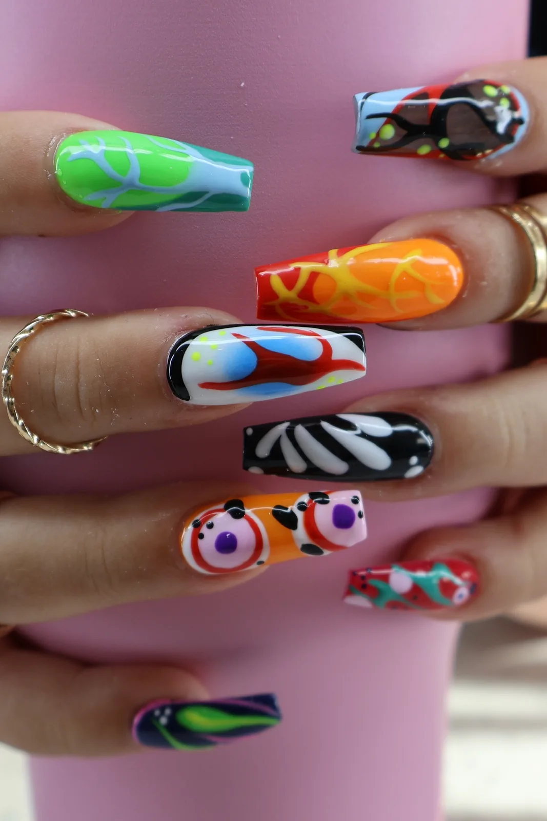 Bold coffin nails with colorful abstract art, zebra print, and neon squiggles