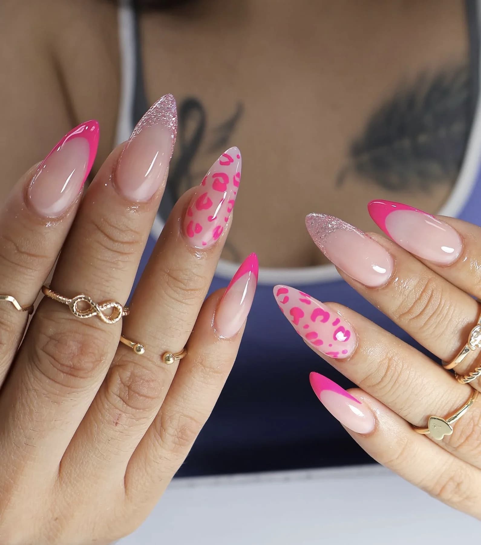 Hot-pink French almond nails with pink leopard print and glitter