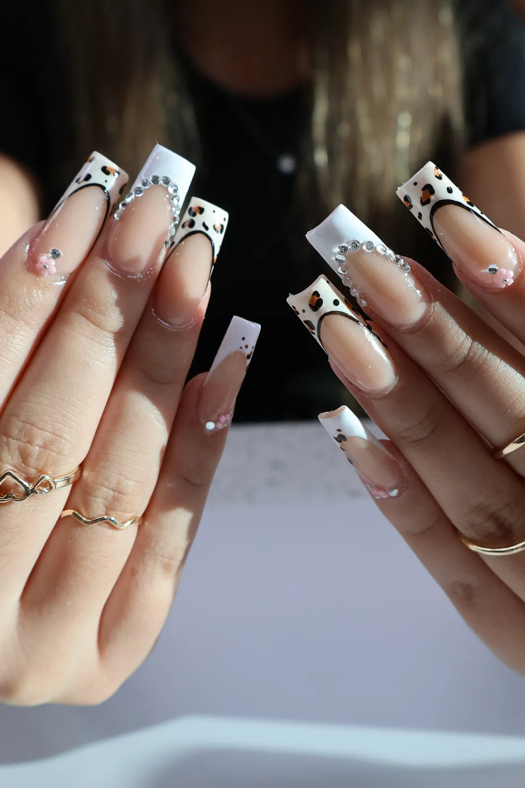 Long square nails with leopard French tips and scattered rhinestones