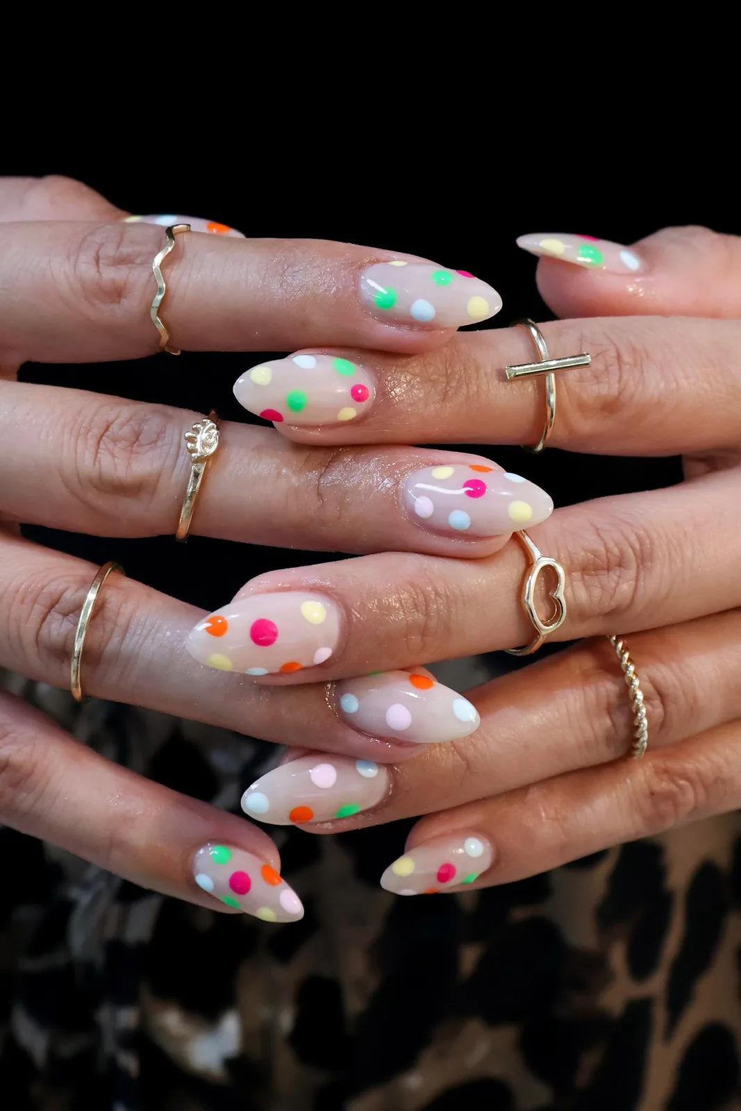 Milky almond nails with multicolored neon polka dots
