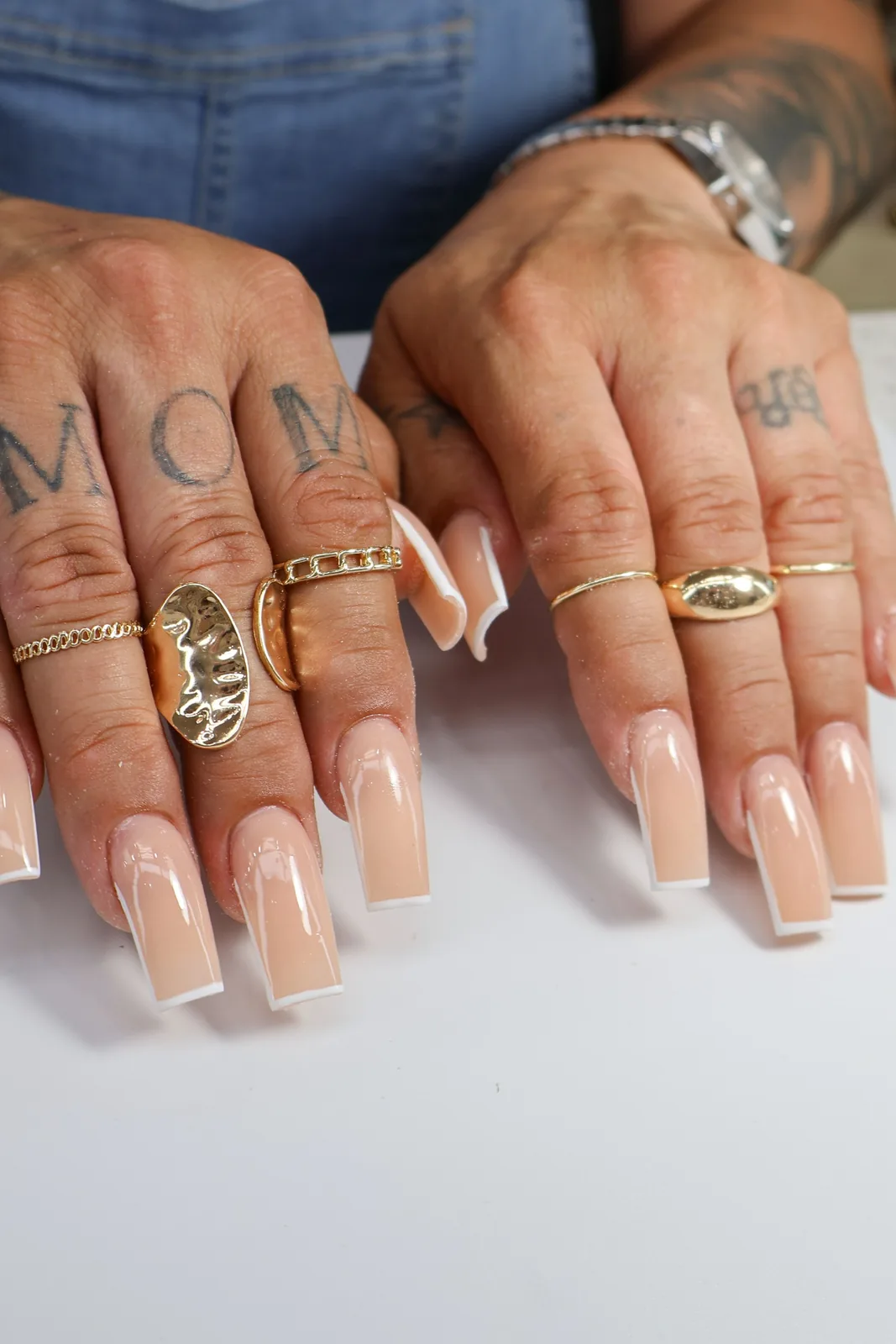 Neutral nude square acrylic set photographed at the nail table