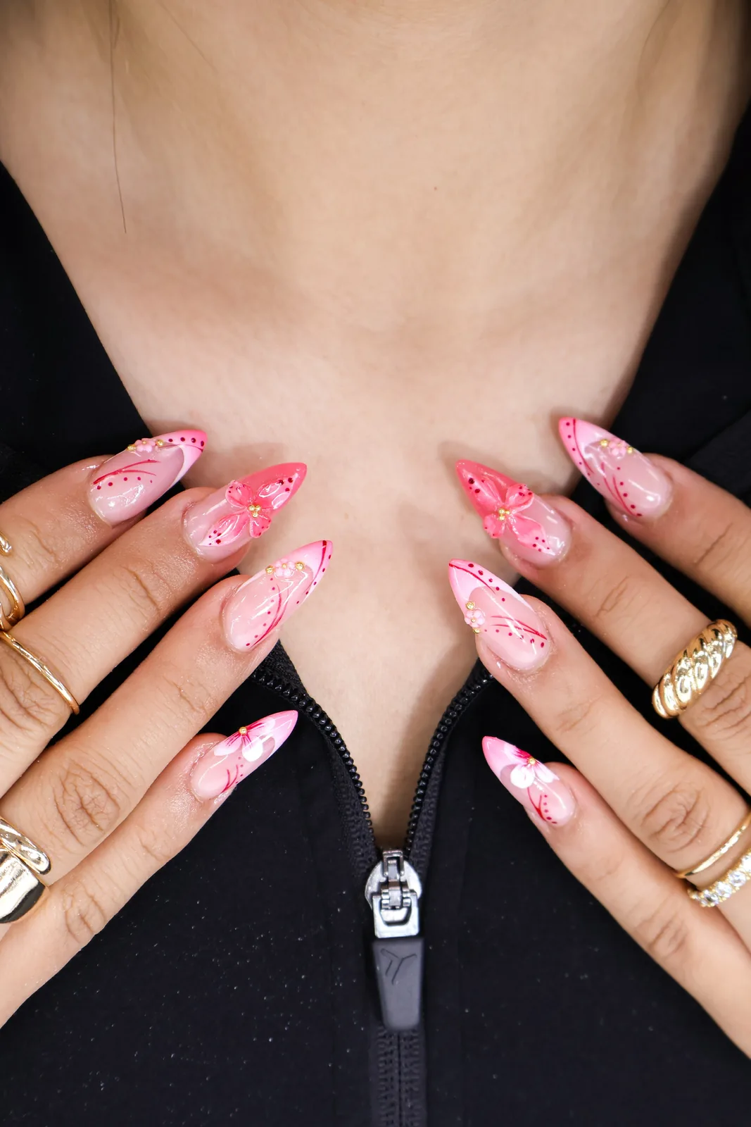 Soft pink French almond nails with hand-painted butterflies and dotted accents
