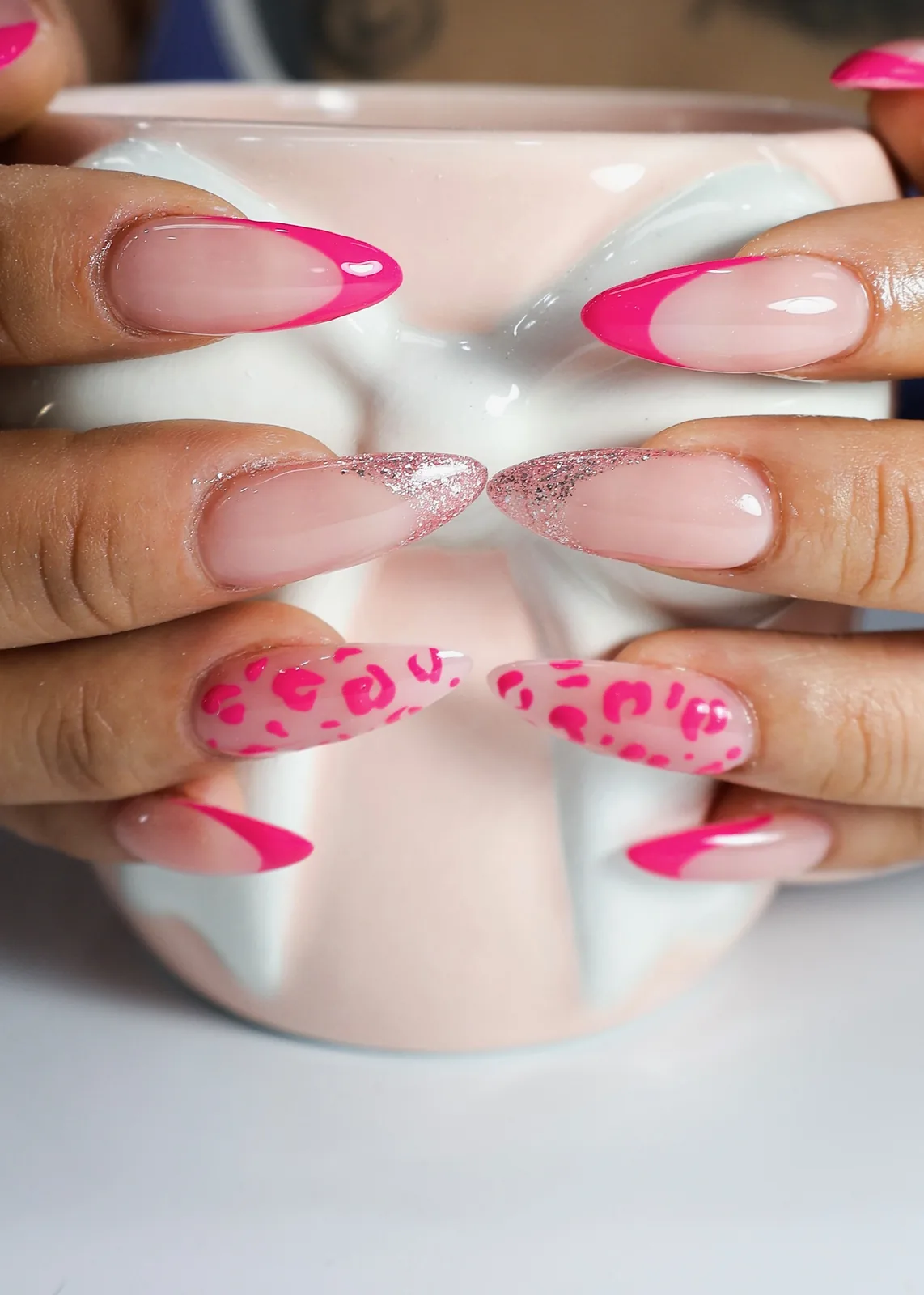 Pink leopard French nails holding a pink bow mug