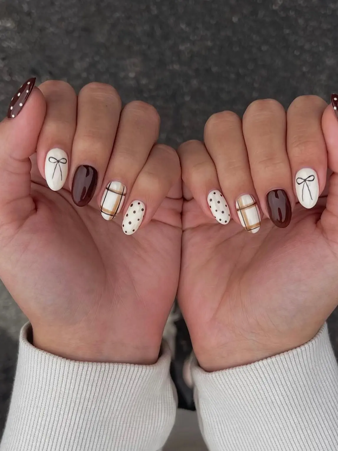 Short nails with cream bow accents, deep chocolate brown, beige plaid and polka-dot accents