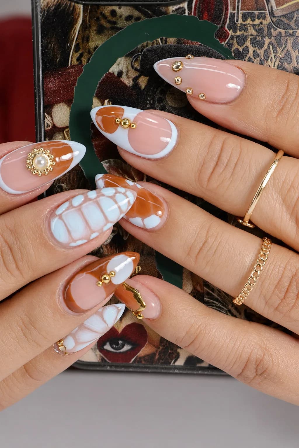 Almond nails mixing tortoiseshell, white crocodile texture, and pearl gold accents