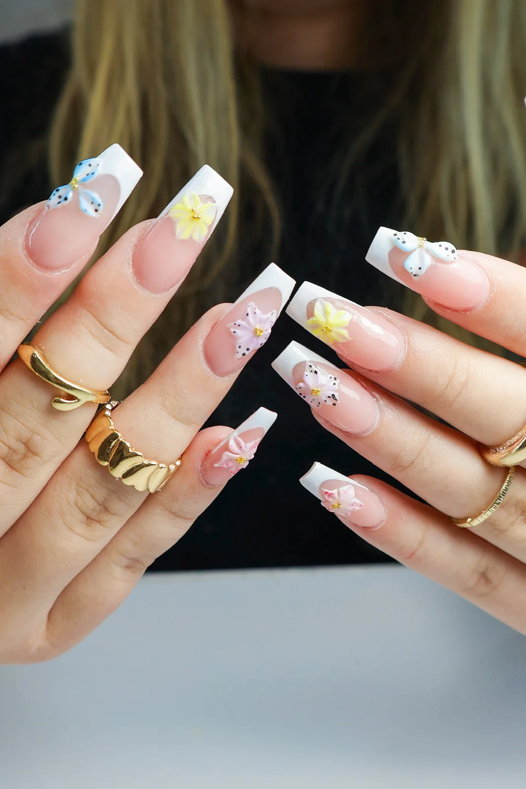 White French coffin nails with yellow flowers and blue butterfly accents