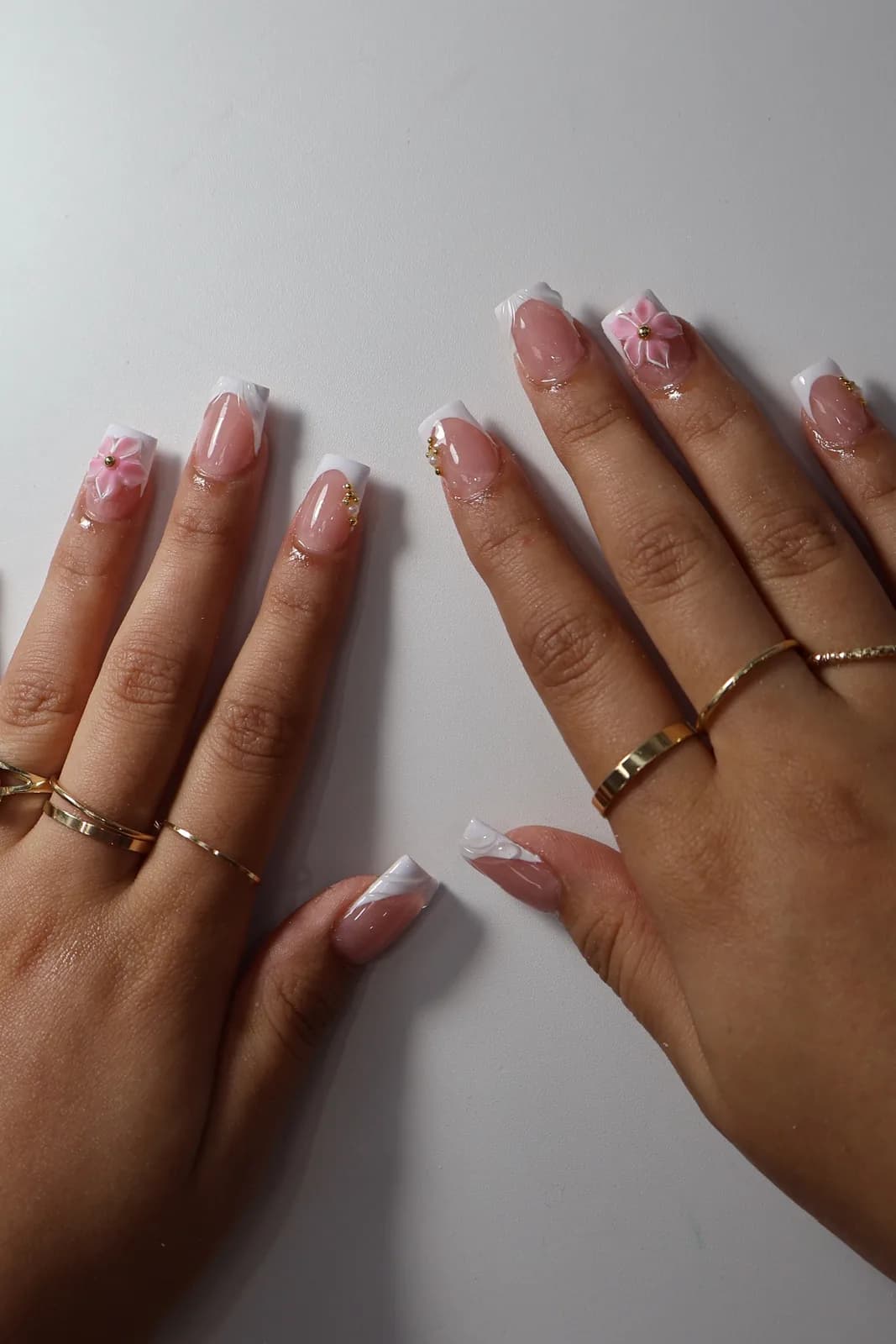 White French square nails with a pink flower accent nail